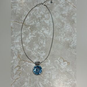 Silver tone snake chain necklace with faceted round blue glass pendant